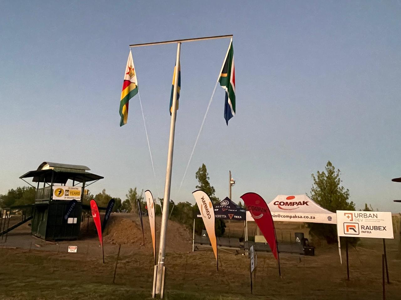 International flags and sponsor banners at dusk