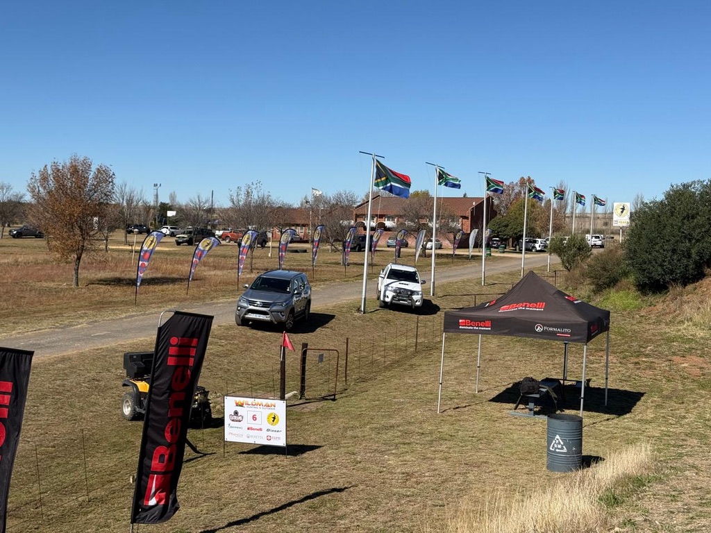 Sponsor banners, vehicles and international flags at the range entrance